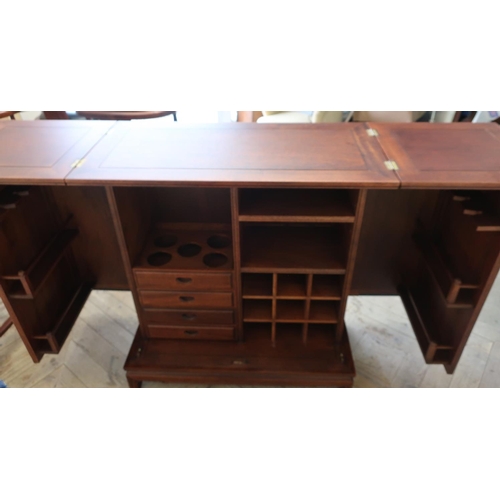 94 - Chinese hardwood bar unit, with twin folding top and two doors enclosing a fitted interior (182cm x ... 