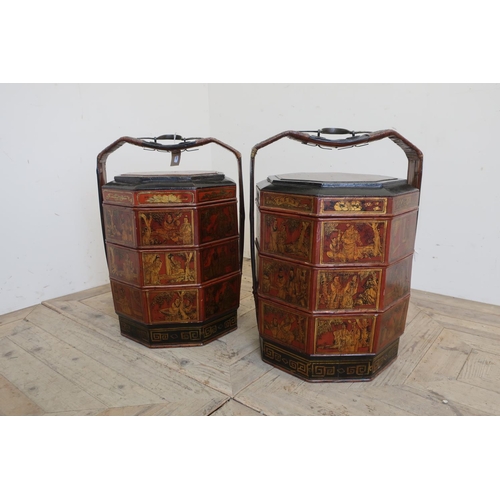 97 - Pair of Chinese lacquered three tier octagonal banquet baskets with wicker bound and metal handles, ... 