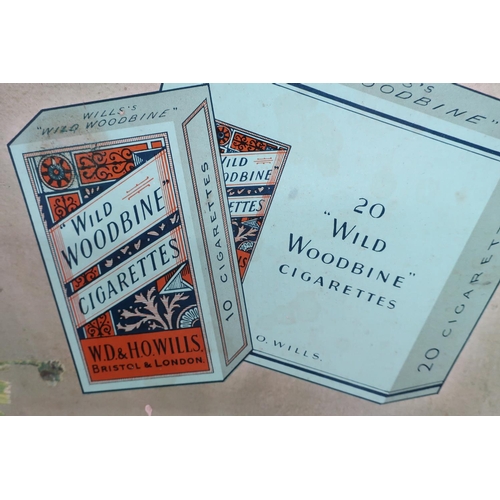 134 - Vintage Wills's Woodbines advert on hardboard backing (58cm x 58cm)