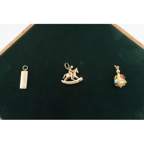 60 - 9ct hallmarked gold articulated rocking horse pendant, a similar ingot pendant and an unmarked gem s... 