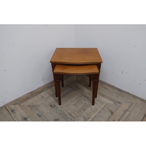 446 - Legante nest of two serpentine teak occasional tables on square tapered supports (37cm x 45cm x 42cm... 