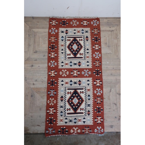 451 - Two brown ground Kilim rugs, both traditional geometric designs (100cm x 205cm) (2)