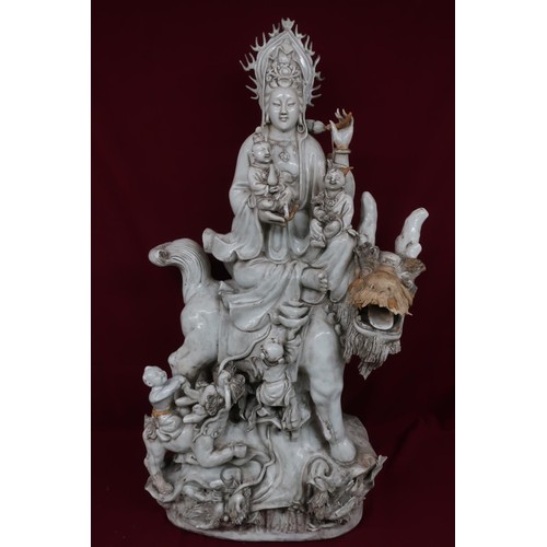 81A - Large blanc-de-chine model of a deity on an exotic animal, with four smaller attendant figures on a ... 