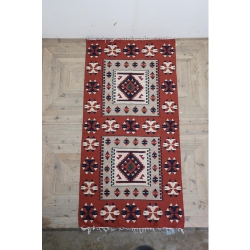 451 - Two brown ground Kilim rugs, both traditional geometric designs (100cm x 205cm) (2)