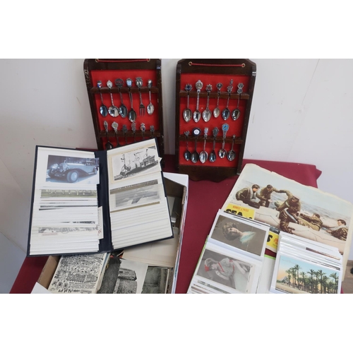 84 - Two albums containing printed and real photographic postcards, loose topographical postcards, some c... 