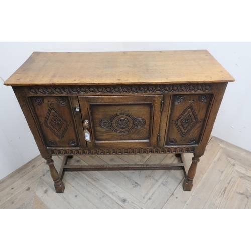 30 - 17th C style oak low side cabinet, with overhanging top, and scroll carved frieze above two lozenge ... 