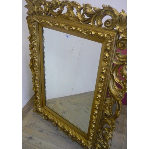 60 - Rectangular wall mirror, in pierced scrollwork gilt frame (15cm x 8cm)