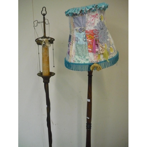 76 - Decorative metal twin headed standard lamp and another carved and turned wood standard lamp (2)