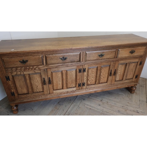 126 - Quality modern oak sideboard with four drawers above four paneled cupboard doors on raised supports ... 
