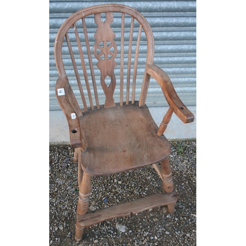 138 - Late Victorian elm child's wheelback high chair, with H shaped understretcher and turned supports