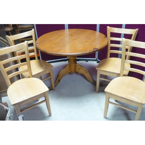382 - Pine circular top cafe style table (approx 110cm) and set of four modern beech ladder back chairs