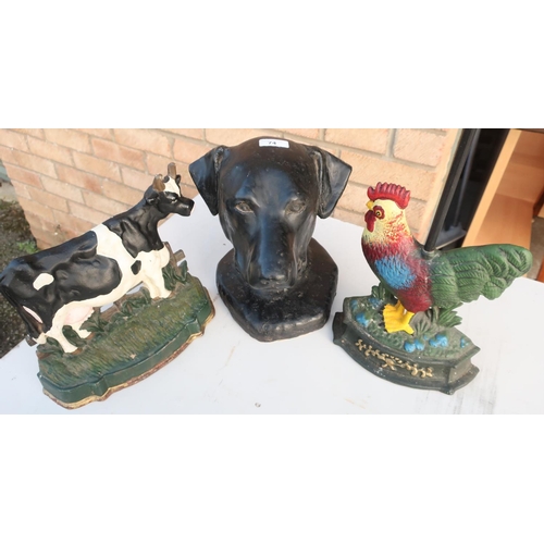 74 - Composite figure of a dogs head, cast metal cockerel doorstop and similar Friesian cow doorstop (3)