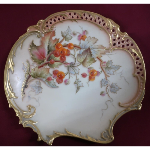 64 - Royal Worcester shaped circular cabinet plate, with pierced border, centre painted with berries on a... 