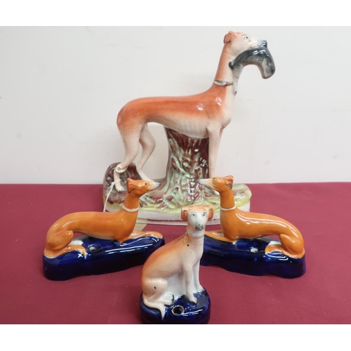 68 - Large Victorian Staffordshire model of a greyhound with a fallen hare, on a natural base (H29cm); pa... 