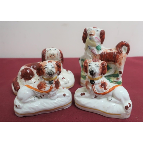 69 - Pair of Staffordshire Spaniels with painted decoration and yellow collars, on oval bases (H7.5cm); a... 