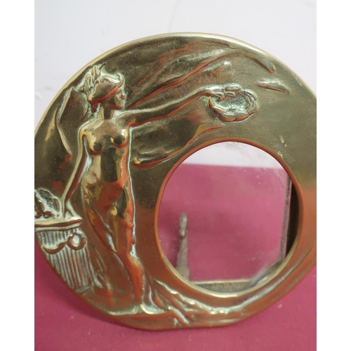 72 - Art Nouveau brass circular easel picture frame decorated in relief with a nude female figure with a ... 