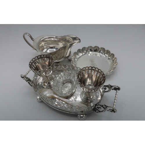 99 - Edwardian EPNS two cup oval egg cruet with pierced borders, scroll handles and ball feet (L.19cm), a... 
