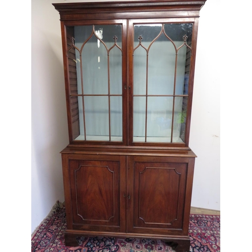 106 - George III mahogany bookcase with dentil cornice above a pair of Gothic astragal glazed doors, the p... 