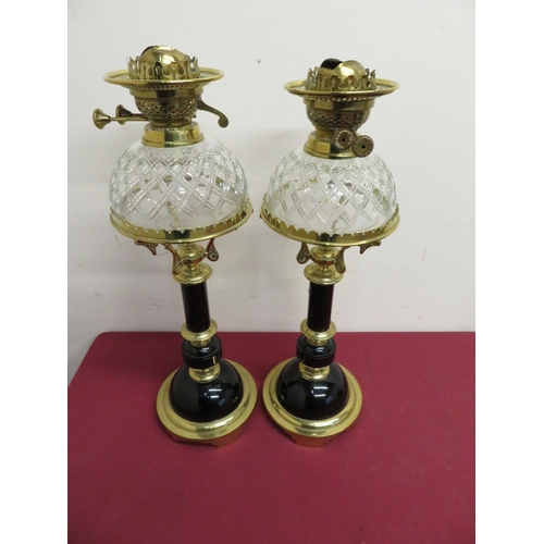 118 - Pair of elaborate 19th C oil lamps with ebonised columns and brass mounts, with cut glass dome shape... 