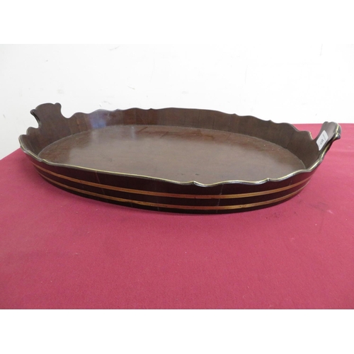 15 - Early 19th C mahogany twin handled oval tray, with brass bound waved gallery (53cm x 37cm).
