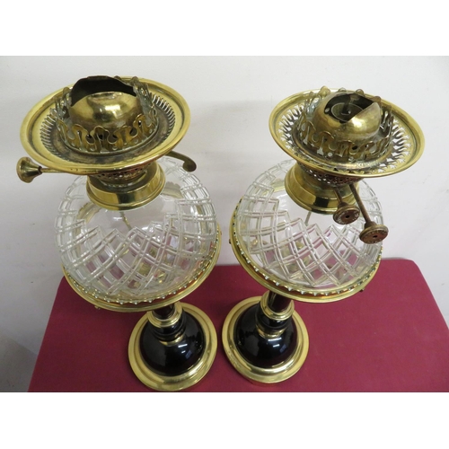 118 - Pair of elaborate 19th C oil lamps with ebonised columns and brass mounts, with cut glass dome shape... 