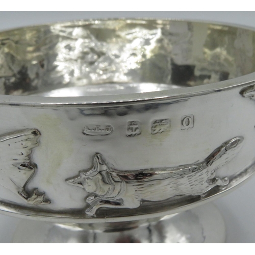 8 - Geo. V silver hallmarked hammered pedestal circular bowl, the rim with fox chasing goose in relief, ... 
