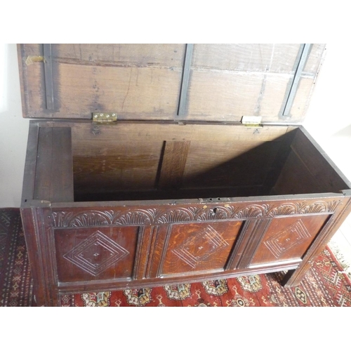 80 - 18th century oak coffer, hinged planked top above  arched carved frieze and three lozenged panelled ... 