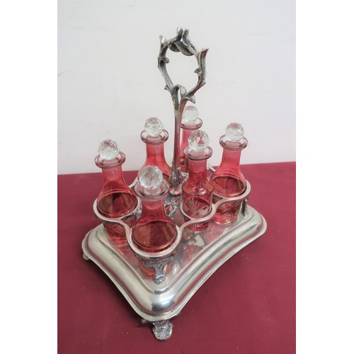 83 - Continental silver plated shaped rectangular six bottle cruet, with six red overlay cut bottles, bra... 