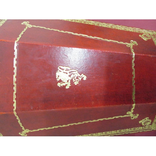 342 - Red and gilt tooled leather wastepaper bin with lion mask handle and central rampant lion detail, wi... 