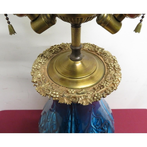 353 - Large relief moulded baluster blue glazed three light table lamp, gilt metal top cast with grape vin... 