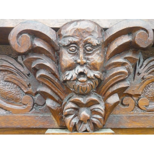 51 - Large Victorian carved oak library bookcase, raised back with moulded cornice, mask and scroll carve... 