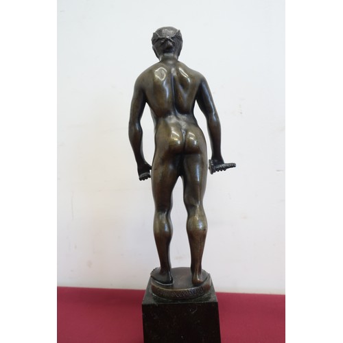 299 - A bronze figure of a naked man wearing roman style laurel to the head with remains of sword in his g... 