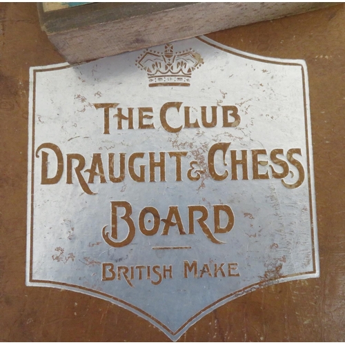 397 - Three chess sets in folding cases, The Club Draughts  and Chessboard and a set of Globe Series draug... 