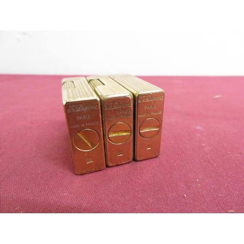 486 - Three DuPont gold plated pocket cigarette lighters, striped design (H4.5cm) stamped DT1107, EB5413 a... 