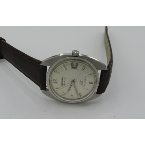 511 - Longines Ultra-Chron automatic wristwatch with date.  Stainless steel case on leather strap.