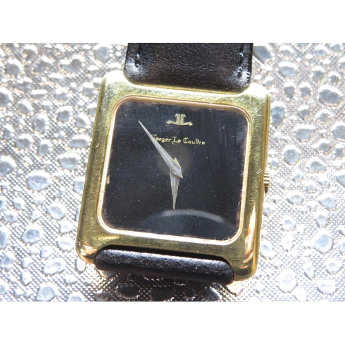 557 - Jaeger Lecoultre hand wound wrist watch.  18K gold case on leather strap, case back stamped 18K, .75... 