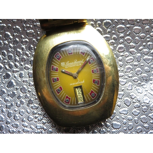 565 - Lucian Piccard Seashark automatic wristwatch with day date.  Gold plated case on matching bracelet. ... 