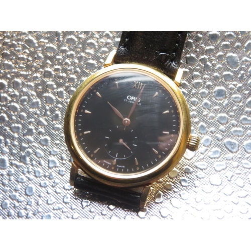 591 - Oris hand wound wristwatch, gold plated case on matching leather strap on non original buckle. Case ... 