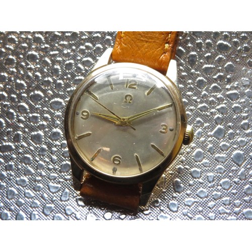 610 - Omega hand wound wristwatch. 9ct gold case on leather strap. Case back stamped Omega Watch Co. 9ct c... 