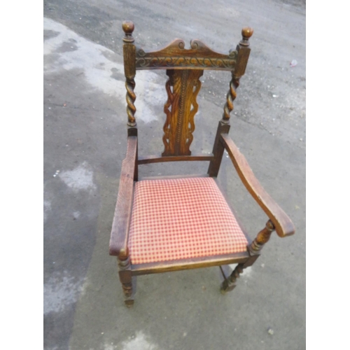 250 - 1930s oak elbow chair, with solid splat, drop in seat on barley twist supports joined by stretcher.