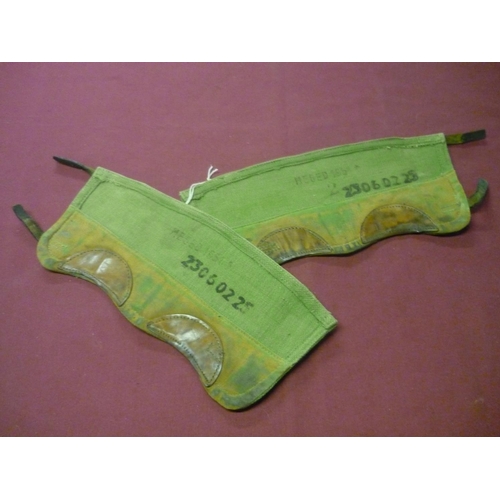 65 - Pair of green canvas and leather Army Putees, stamped NEEED 1951 with broad arrow and numbered 23060... 