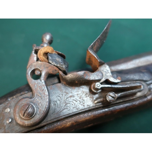 56 - 19th C Flintlock holster pistol with 10inch octagonal barrel and stirrup ram rod with engraved scrol... 