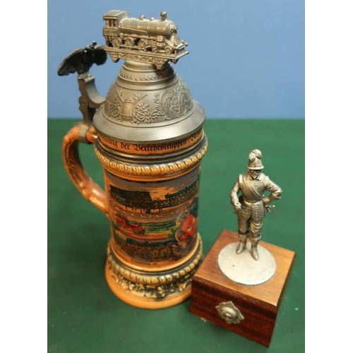 168 - Pewter statuette and a German beer stein, the pewter lid with eagle and railway engine (2)