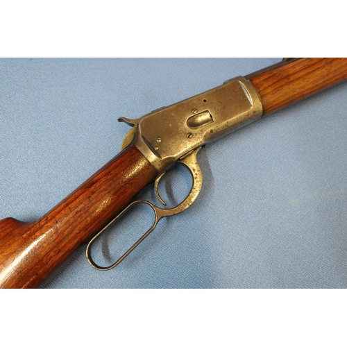 570 - Winchester under lever 38 WCF rifle, with 23 inch octagonal barrel, engraved to the top rib 