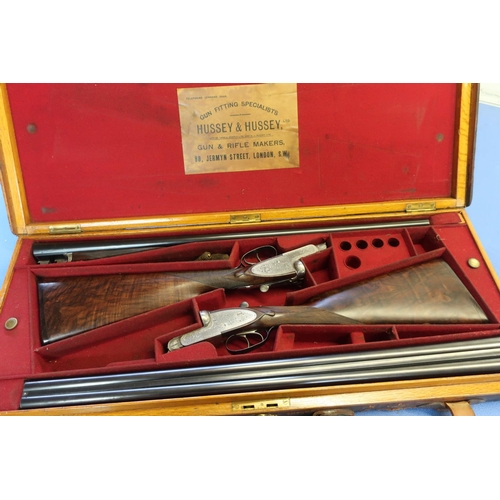 588 - Cased pair of Hussey & Hussey 12B side by side sidelock ejector shotguns, with 28 inch barrels, 2 1/... 