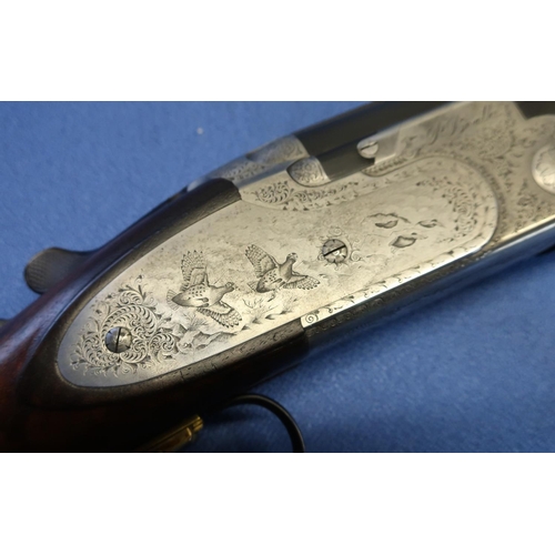 637 - Cased Beretta 687 EELL sporting 12B over and under sidelock ejector shotgun, with 28 inch multichoke... 