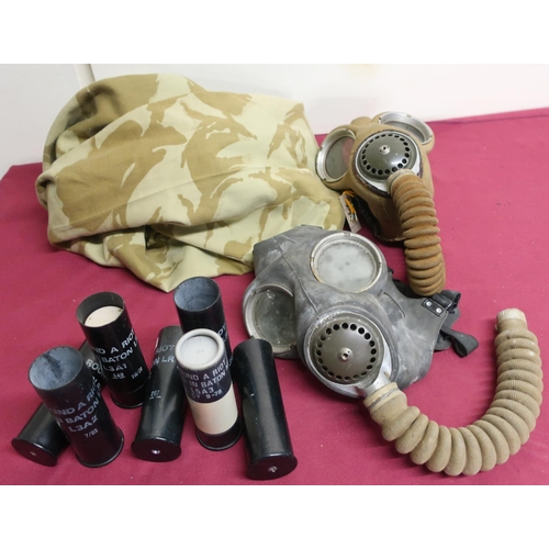 140 - Two British gas masks, lacking canister (display purposes only), various empty baton round casings a... 