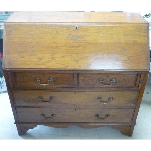 106 - 19th C oak bureau with fall front revealing fitted interior above two short and two long drawers, on... 