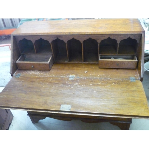 106 - 19th C oak bureau with fall front revealing fitted interior above two short and two long drawers, on... 