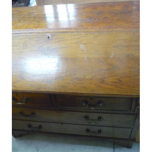 106 - 19th C oak bureau with fall front revealing fitted interior above two short and two long drawers, on... 